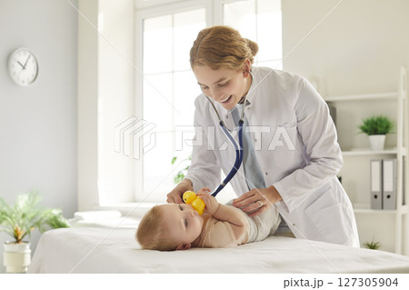 Pediatrician Using Stethoscope To Examine Baby Lungs At Clinic 127305904