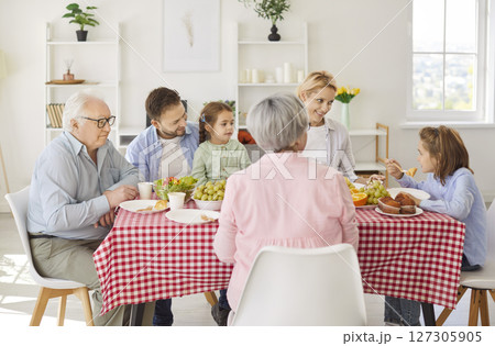 Happy family gathering union meal at home, grandparents, mother, father with two small children Happy family gathering union meal at home, grandparents, mother, father with two small children 127305905