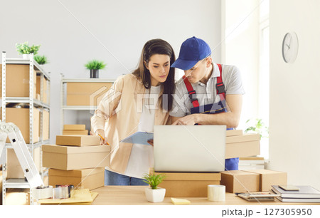 Man And Woman Working With Laptop Together In Warehouse 127305950