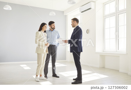 Real Estate Agent Showing New Home To Couple Real Estate Agent Showing New Home To Couple 127306002