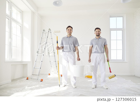 Smiling successful male painters or construction workers, professional service team standing Smiling successful male painters or construction workers, professional service team standing 127306015