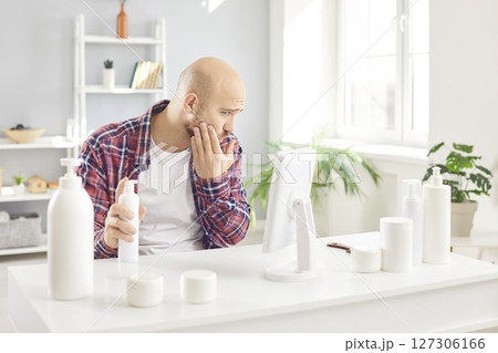 Young man relaxing doing spa pedicure at home. Male beauty spa day and skin care concept Young man relaxing doing spa pedicure at home. Male beauty spa day and skin care concept 127306166