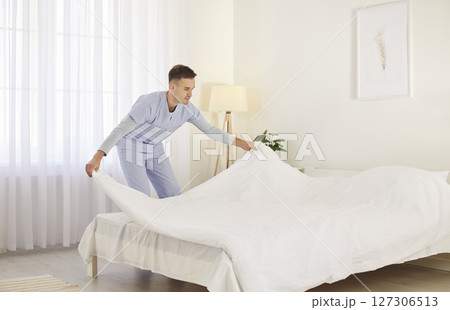 Doctor Or Caregiver Making Bed At Nursing Home Or Hospital 127306513