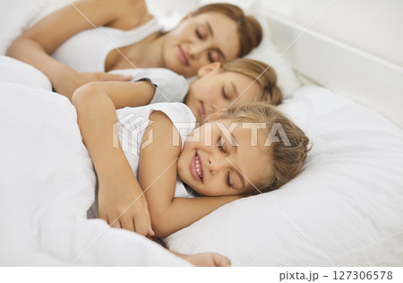 Mother And Kids Sleeping Or Napping Together In Bed Early In The Morning At Home Mother And Kids Sleeping Or Napping Together In Bed Early In The Morning At Home 127306578