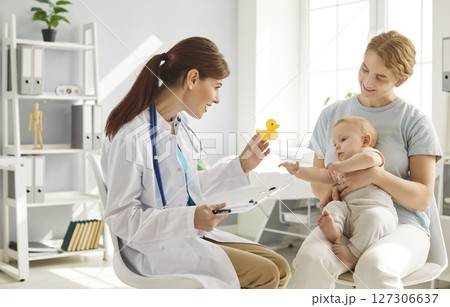 Pediatrician Consulting With Mother And Baby In A Hospital Office Pediatrician Consulting With Mother And Baby In A Hospital Office 127306637