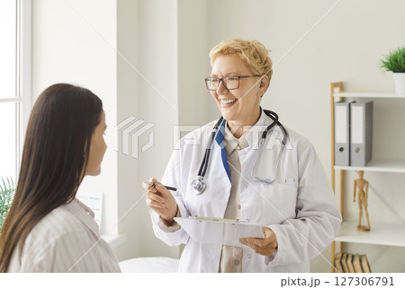 Elderly Doctor Or Nurse Consulting A Patient In A Hospital Elderly Doctor Or Nurse Consulting A Patient In A Hospital 127306791