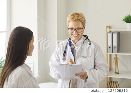 Senior Doctor Conducting Medical Appointment At Hospital Senior Doctor Conducting Medical Appointment At Hospital 127306816
