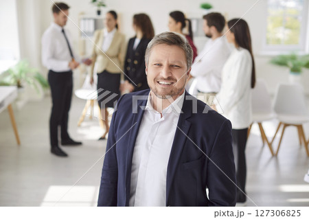 Portrait Of A Happy Smiling Businessman Working In Office Portrait Of A Happy Smiling Businessman Working In Office 127306825