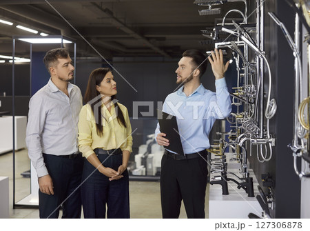 Salesman Consulting Couple In Plumbing Store For Shower Salesman Consulting Couple In Plumbing Store For Shower 127306878