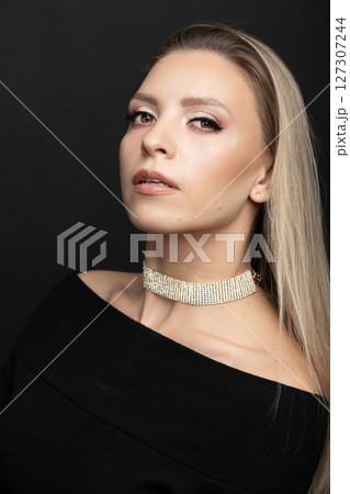 Beautiful brunette woman with black dress and fancy jewelry studio portrait Beautiful brunette woman with black dress and fancy jewelry studio portrait 127307244