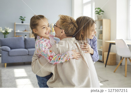 Grandchildren and grandmother happy family meet, hug together, friendly playing at home 127307251