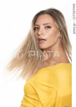 Beautiful woman with yellow dress studio portrait in white background Beautiful woman with yellow dress studio portrait in white background 127307449