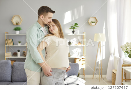 Loving couple gentle feeling of fondness future parents expecting first baby close at home, caring Loving couple gentle feeling of fondness future parents expecting first baby close at home, caring 127307457