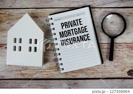 Private Mortgage Insurance text on paper notebook with white house model and magnifying glass on wood background 127308064