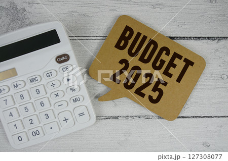 Budget 2025 text with calculator on wooden background 127308077