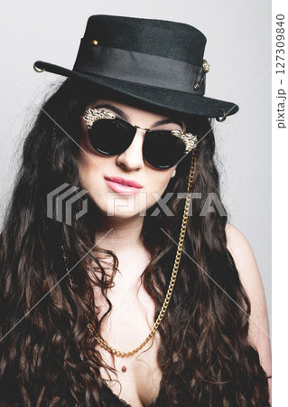 Beautiful woman with hat and sunglasses studio portrait 127309840