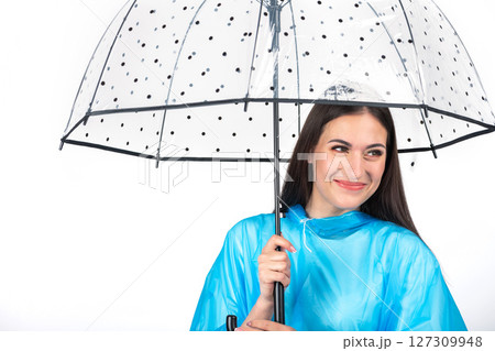 Woman with blue raincoat and umbrella studio portrait 127309948