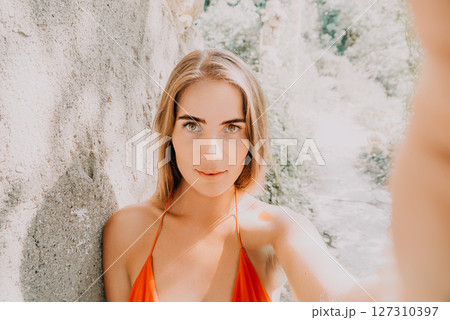 Woman Selfie Summer Vacation Outdoor - Woman taking a selfie outdoors during her summer vacation. 127310397