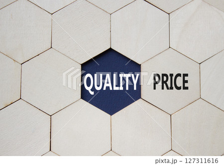 Price or Quality symbol. Concept word Price or Quality on wooden comb puzzle. Beautiful deep blue background. Business and Price or Quality concept. Copy space Price or Quality symbol. Concept word Price or Quality on wooden comb puzzle. Beautiful deep blue background. Business and Price or Quality concept. Copy space 127311616