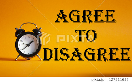 Agree to Disagree symbol. Beautiful orange background with alarm clock. Business and Agree to Disagree concept. Copy space. Agree to Disagree symbol. Beautiful orange background with alarm clock. Business and Agree to Disagree concept. Copy space. 127311635