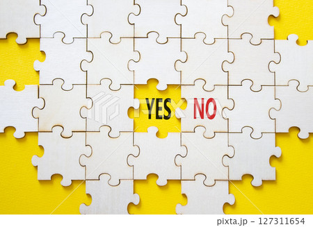 Yes or No symbol. Concept word Yes or No on wooden puzzle. Beautiful yellow background. Business and Yes or No concept. Copy space 127311654