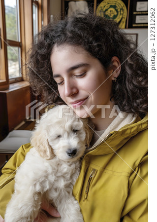 Young woman holding a fluffy puppy in a cozy veterinary clinic with warm wooden accents Young woman holding a fluffy puppy in a cozy veterinary clinic with warm wooden accents 127312062