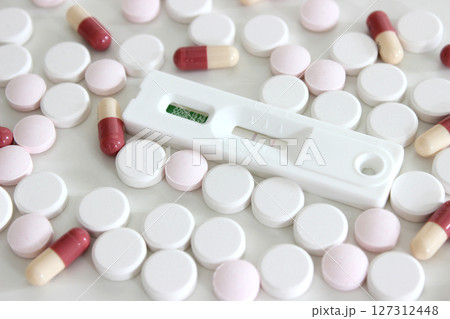 Positive test result of Covid-19 antigen test kit and drugs isolated on the white background 127312448
