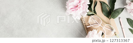 Flat Lay with Peonies, Notebook, and Eyeglasses on Gray Surface 127313367