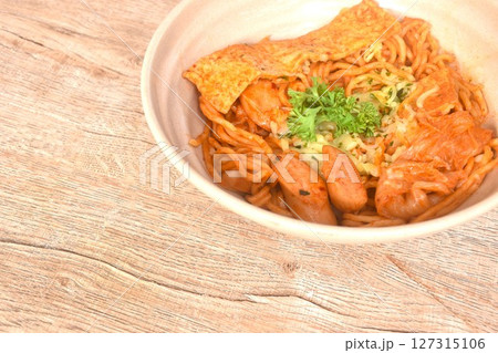 stir ramen Japanese noodles with slice pork sausage and tofu with cabbage in Korean kimchi sauce on bowl stir ramen Japanese noodles with slice pork sausage and tofu with cabbage in Korean kimchi sauce on bowl 127315106