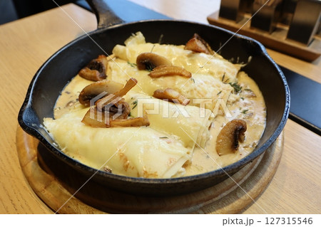 Indulge in the mouthwatering goodness of Delicious Cheesy Mushroom Enchiladas made in a Skillet 127315546