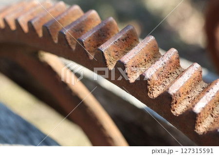 CloseUp View of Rusty Gear Teeth Found in a Detailed Industrial Setting and Environment 127315591