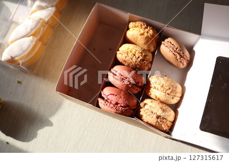 A Delicious and Colorful Assortment of Artisanal Macarons Perfectly Packaged in a Box 127315617