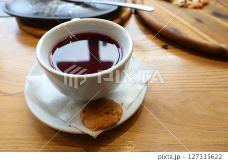 Enjoy a Delicious Berry Infusion paired with a Scrumptious Cookie on a Wooden Table Enjoy a Delicious Berry Infusion paired with a Scrumptious Cookie on a Wooden Table 127315622