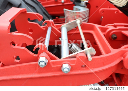 A CloseUp Image of Red Agricultural Equipment Components Showcasing Their Details and Features A CloseUp Image of Red Agricultural Equipment Components Showcasing Their Details and Features 127315665