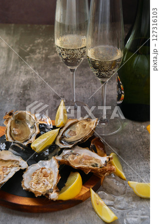 Oysters, fresh lemons and champagne 127316103