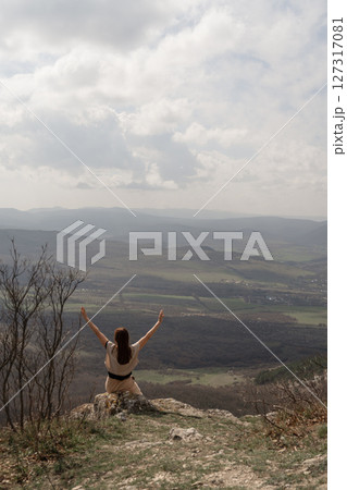 Woman Mountain View, happy girl stretches arms atop hill during daytime to enjoy freedom and landscape. Woman Mountain View, happy girl stretches arms atop hill during daytime to enjoy freedom and landscape. 127317081