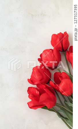 A bouquet showcasing beautiful red tulips against a soft light background, perfect for adding color and charm to any setting 127317395