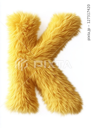 A vibrant fluffy yellow letter K sits prominently against a bright white background, exuding a fun and playful vibe suited for decorative purposes 127317420