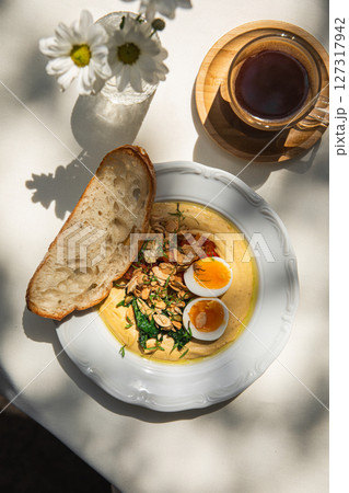 Portion of breakfast with hummus and eggs Portion of breakfast with hummus and eggs 127317942