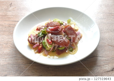 spicy and sour sweet slice Chinese pork sausage with vegetable salad on plate   127319643