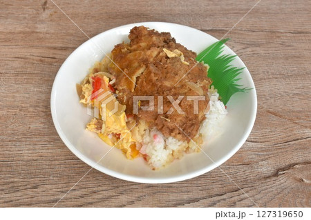 deep fried slice pork with egg or tonkatsu with Japanese pickled vegetable on rice in plate deep fried slice pork with egg or tonkatsu with Japanese pickled vegetable on rice in plate 127319650