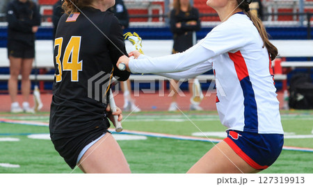 Intense Lacrosse Match Between Two Competitive Girls Teams Intense Lacrosse Match Between Two Competitive Girls Teams 127319913
