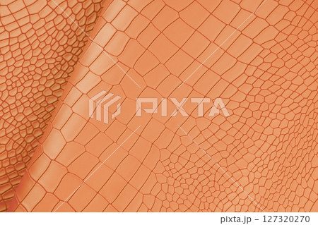 Orange color artificial crocodile leather texture background. Orange color artificial crocodile leather texture background. 127320270