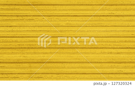 Bright yellow textured background creating horizontal lines with darker specks 127320324