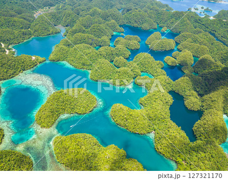 Rainforest hills and azure water in lagoon with clouds. Sohoton Cove. Bucas Grande Island. Mindanao, Philippines. Rainforest hills and azure water in lagoon with clouds. Sohoton Cove. Bucas Grande Island. Mindanao, Philippines. 127321170