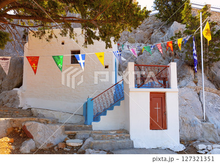 Chapel with flags in Symi, Greece Chapel with flags in Symi, Greece 127321351