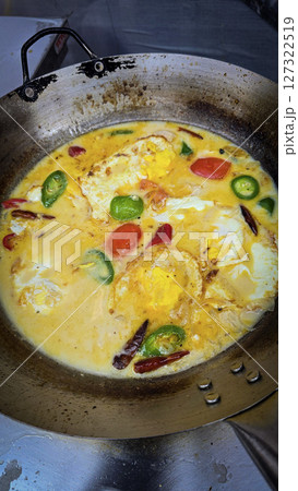 Rich Spicy Egg soup Dish with coconut milk and Vegetables in Rustic Pan, for illustrating authentic home cooking meals 127322519