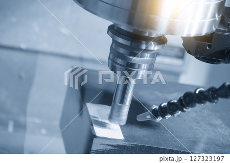 The CNC milling machine rough cutting the mold parts by indexable tools in the light blue scene. The CNC milling machine rough cutting the mold parts by indexable tools in the light blue scene. 127323197