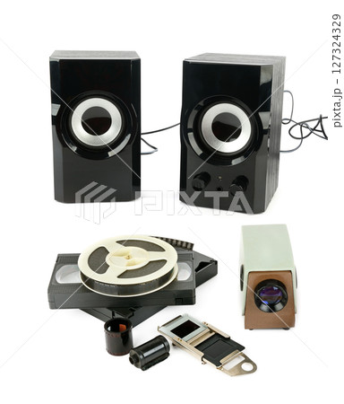 Film strips, bookshelf speaker, film projector, films and videotapes isolated on white background. Collage. 127324329