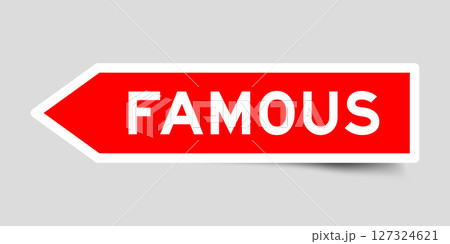 Red color arrow shape sticker label with word famous on gray background 127324621